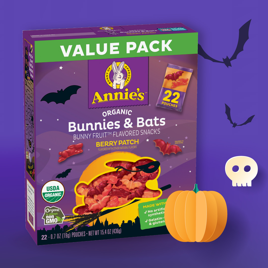 Annie's Organic Bunnies & Bats Fruit Snack box displayed on a purple background with bat, skull, and pumpkin illustrations.